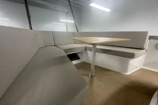 Slide: The Image of 2023 Fjord 38 Xpress interior with modern seating and wooden table. - 21