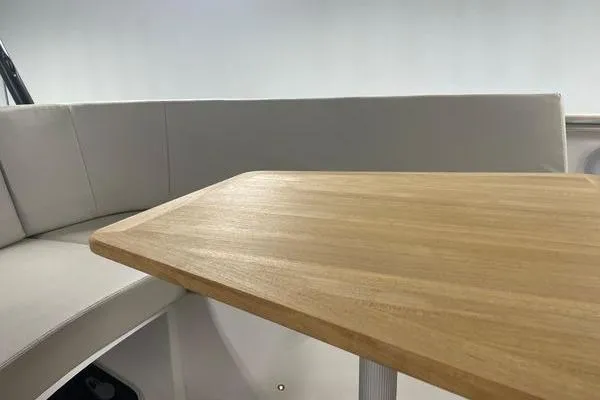 Slide: The Image of 2023 Fjord 38 Xpress interior with wooden table and cushioned seating. - 27