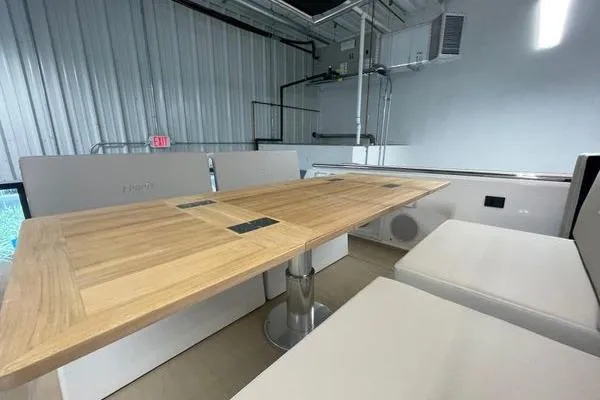 Slide: The Image of 2023 Fjord 38 Xpress interior with wooden table and cushioned seating. - 37