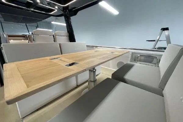 Slide: The Image of 2023 Fjord 38 Xpress interior with modern seating and wooden table. - 39