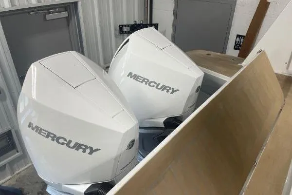 Slide: The Image of 2023 Fjord 38 Xpress with dual Mercury outboard engines in a storage facility. - 43