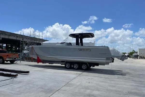 Slide: The Image of 2023 Fjord 38 Xpress boat on trailer under clear blue sky. - 5