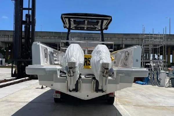 Slide: The Image of 2023 Fjord 38 Xpress boat with dual engines, docked under clear blue sky. - 8