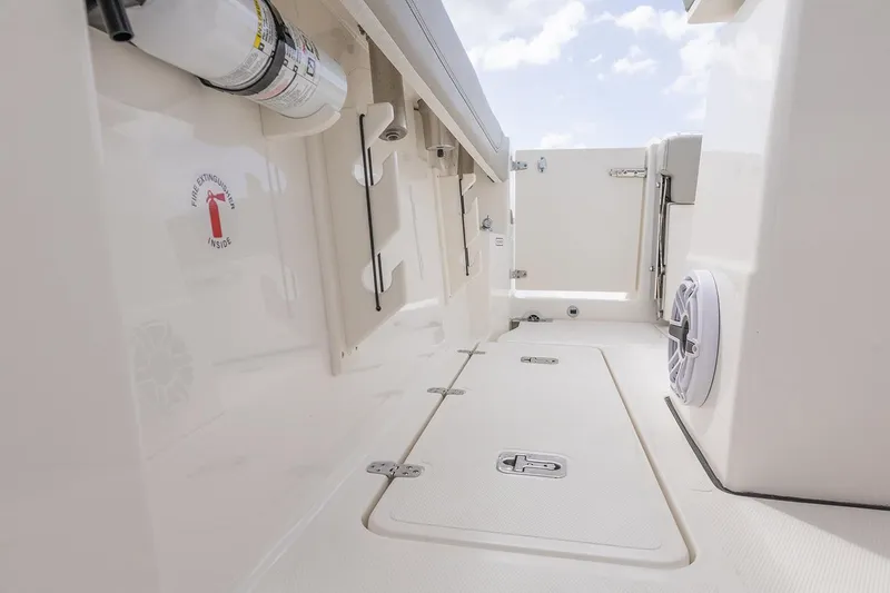 Slide: The Image of Manufacturer Provided Image: 2025 Pursuit S 248 Sport boat interior, featuring storage compartments and sleek design elements. - 13