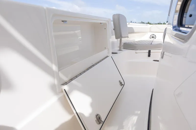 Slide: The Image of Manufacturer Provided Image: 2025 Pursuit S 248 Sport boat interior with open storage compartment and seating. - 14