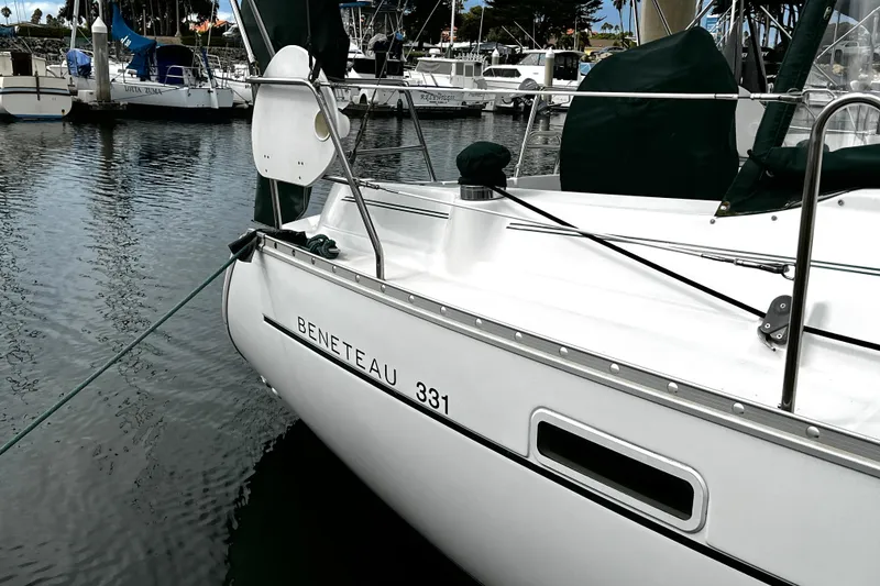 Slide: The Image of 2002 Beneteau 331 sailboat docked in a marina, showcasing sleek design and craftsmanship. - 11