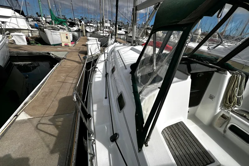 Slide: The Image of 2002 Beneteau 331 sailboat docked at marina, featuring spacious deck and cockpit area. - 15