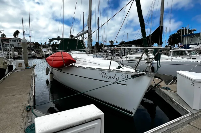 Slide: The Image of 2002 Beneteau 331 sailboat docked in marina with red kayak on deck. - 2