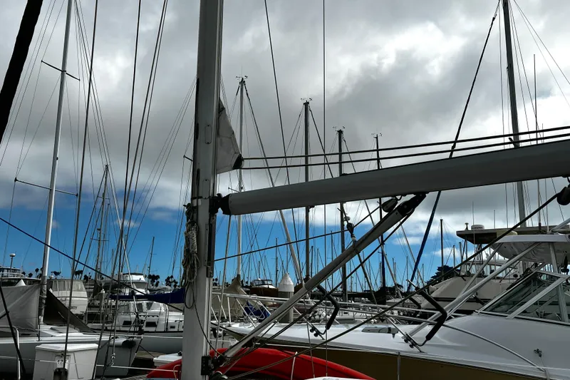 Slide: The Image of Marina with sailboats, including a 2002 Beneteau 331, under cloudy skies. - 20