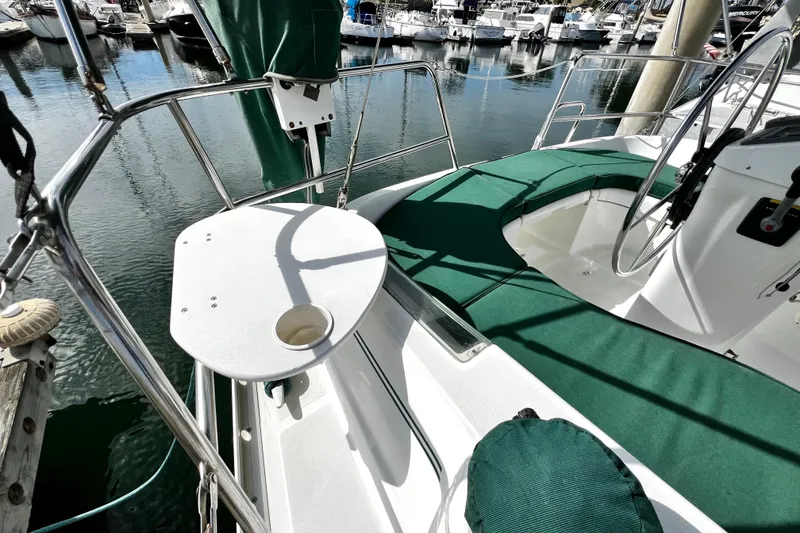 Slide: The Image of Cockpit of 2002 Beneteau 331 sailboat with green seating and steering wheel. - 28