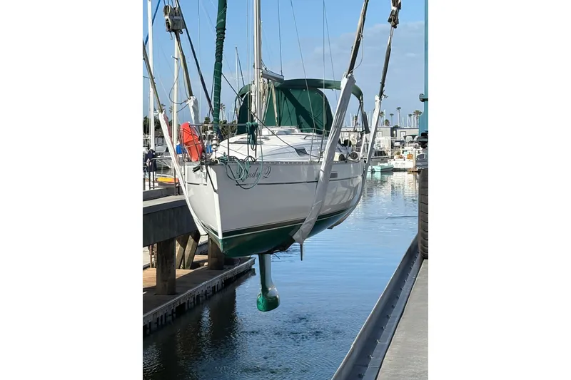 Slide: The Image of 2002 Beneteau 331 sailboat suspended over water at a marina. - 3