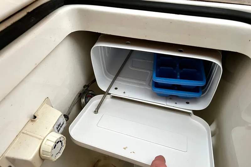 Slide: The Image of Open storage compartment on 2002 Beneteau 331 boat with ice trays inside. - 36