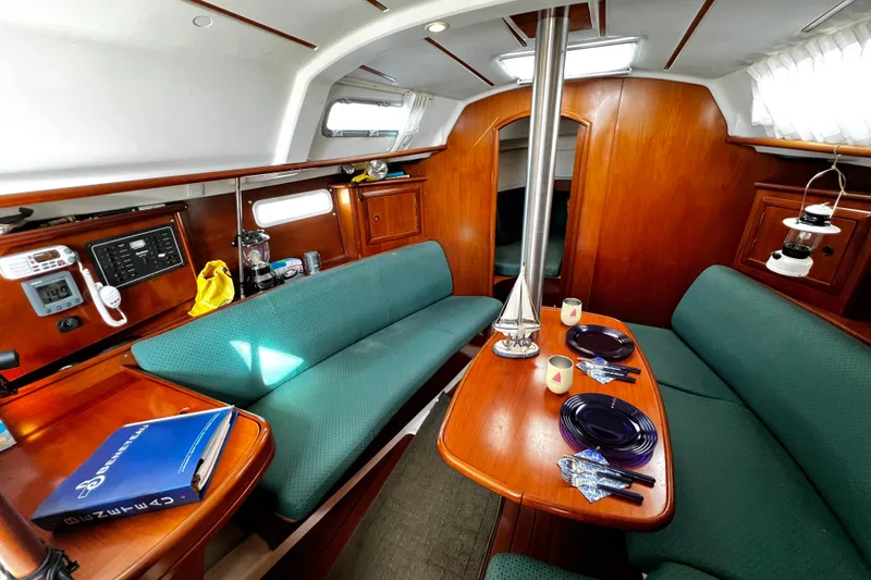 Slide: The Image of Interior of 2002 Beneteau 331 sailboat with cozy seating and dining area. - 39