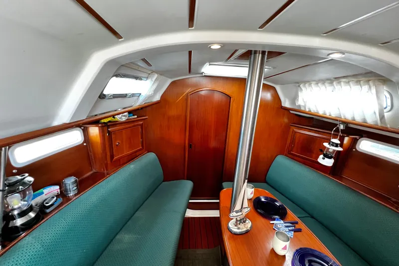 Slide: The Image of Interior of 2002 Beneteau 331 sailboat with wood finish and green seating. - 41