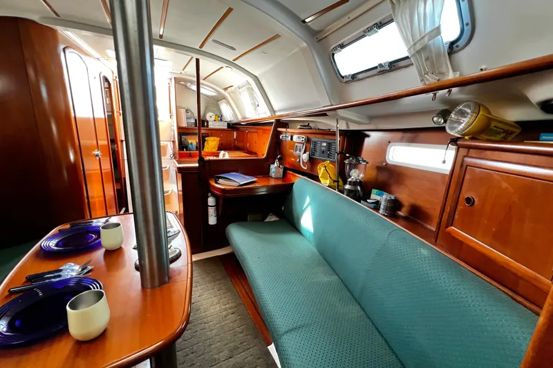 Slide: The Image of Interior of 2002 Beneteau 331 sailboat with cozy seating and dining area. - 42