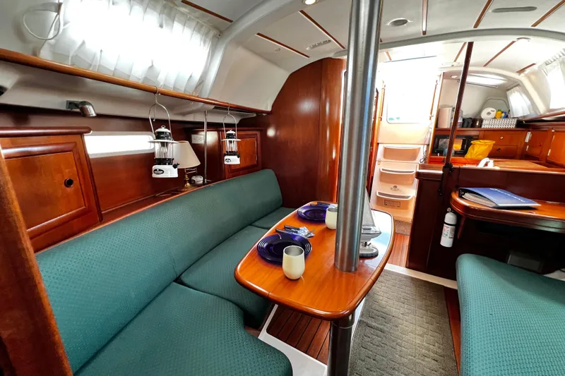 Slide: The Image of Interior of 2002 Beneteau 331 sailboat with cozy seating and dining area. - 43