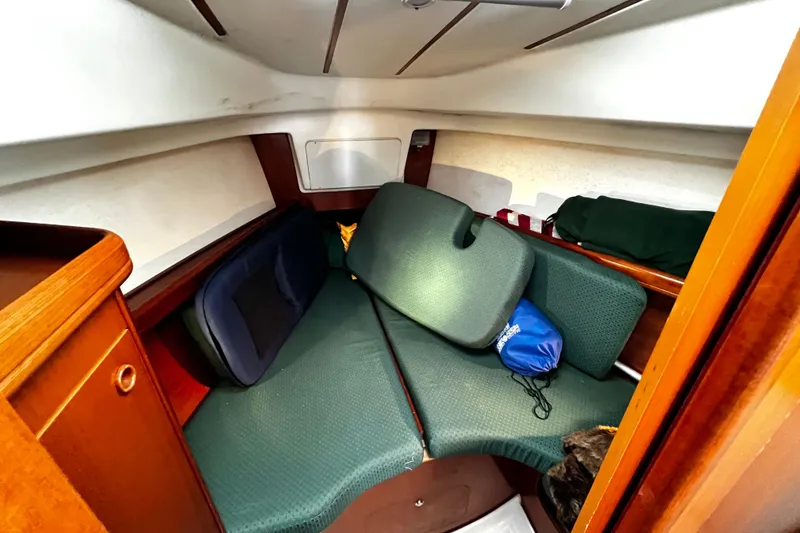 Slide: The Image of Cozy cabin interior of a 2002 Beneteau 331 sailboat with green cushions. - 45