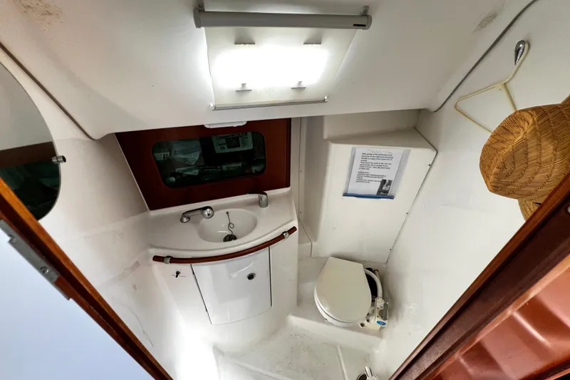 Slide: The Image of 2002 Beneteau 331 yacht bathroom with sink, toilet, and storage. - 47