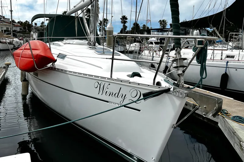Slide: The Image of 2002 Beneteau 331 sailboat docked, featuring a red kayak on deck. - 5