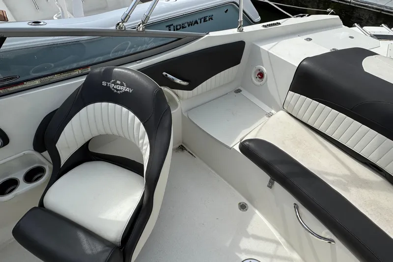 Slide: The Image of 2018 Stingray 204 LR boat interior with black and white seating, showcasing luxury design. - 12