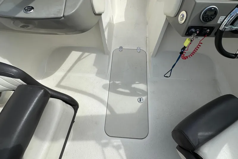 Slide: The Image of 2018 Stingray 204 LR boat interior with seating and control panel. - 15