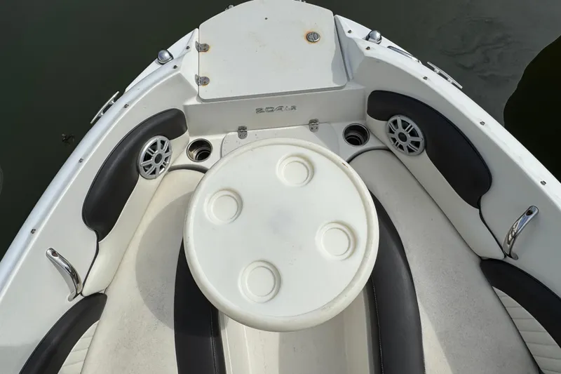 Slide: The Image of 2018 Stingray 204 LR boat interior with seating and round table. - 18
