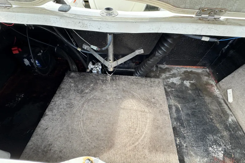 Slide: The Image of 2018 Stingray 204 LR boat interior showing engine compartment and wiring. - 8