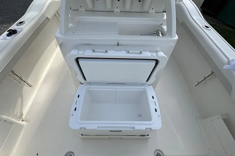 Slide: The Image of 2026 Key West 239 FSR boat interior with open cooler and storage area. - 12