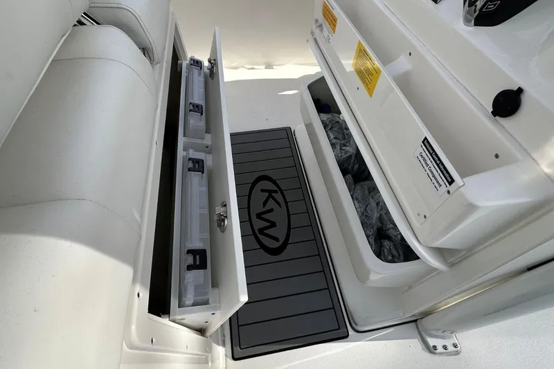 Slide: The Image of 2026 Key West 239 FSR boat storage compartments with KW logo mat. - 17
