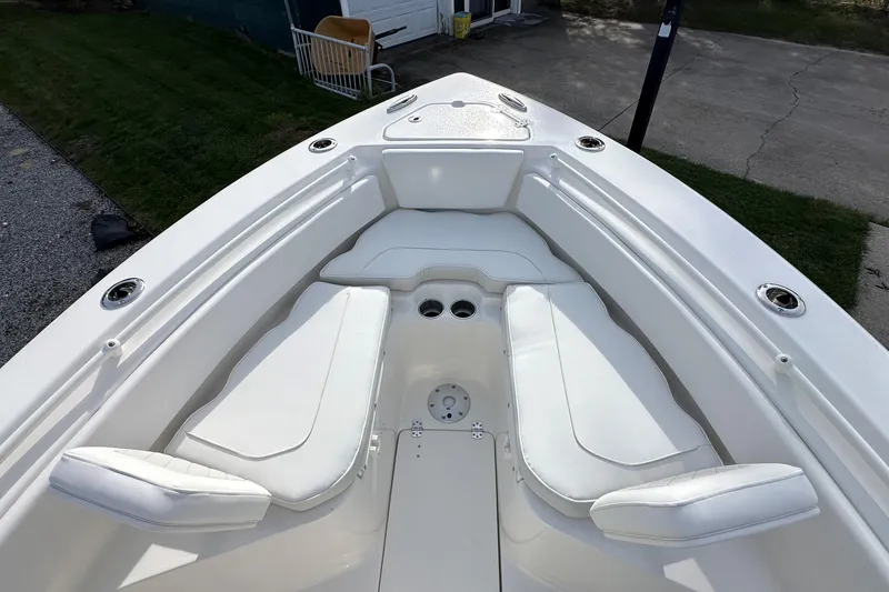 Slide: The Image of 2026 Key West 239 FSR boat interior with white cushioned seating. - 23