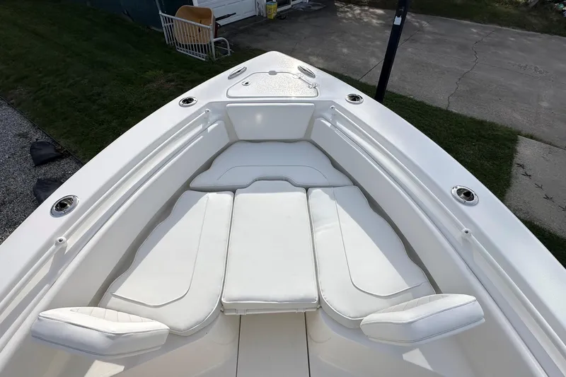 Slide: The Image of 2026 Key West 239 FSR boat with white cushioned seating and sleek design. - 25