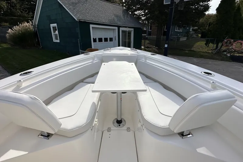 Slide: The Image of 2026 Key West 239 FSR boat interior with white seating and table. - 28