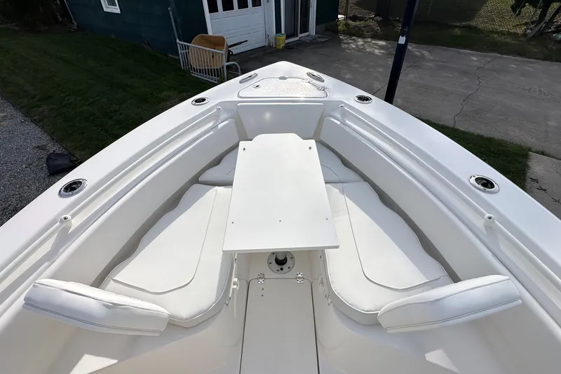 Slide: The Image of 2026 Key West 239 FSR boat interior with white seating and table. - 29