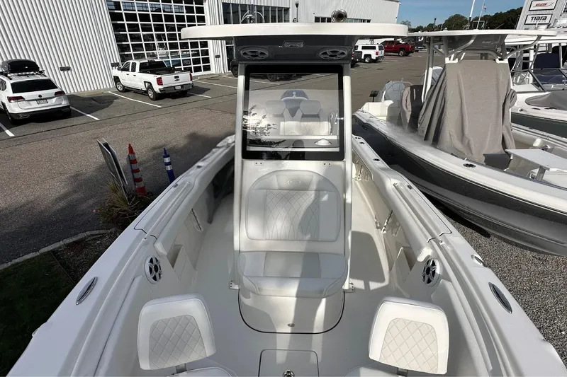 Slide: The Image of 2026 Key West 239 FSR boat, white interior, parked at a dealership. - 32