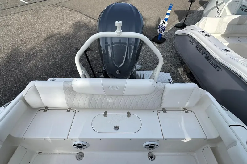 Slide: The Image of 2026 Key West 239 FSR boat with white seating and outboard motor, displayed outdoors. - 7