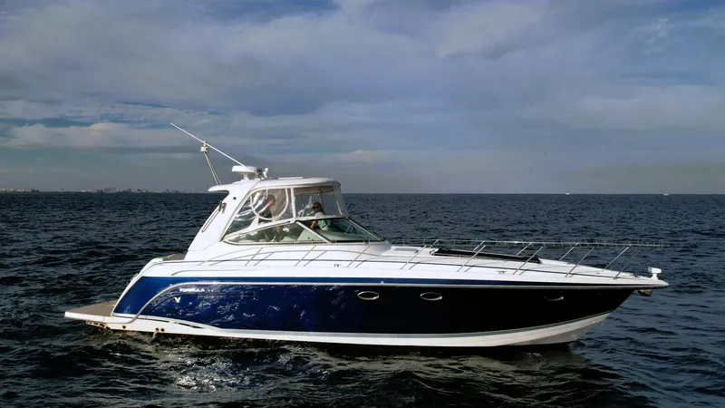 The Image of 2006 Formula 40 PC yacht cruising on open water under a cloudy sky. - 0