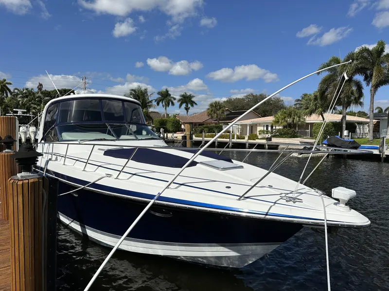 Slide: The Image of 2006 Formula 40 PC yacht docked in sunny marina with palm trees. - 12