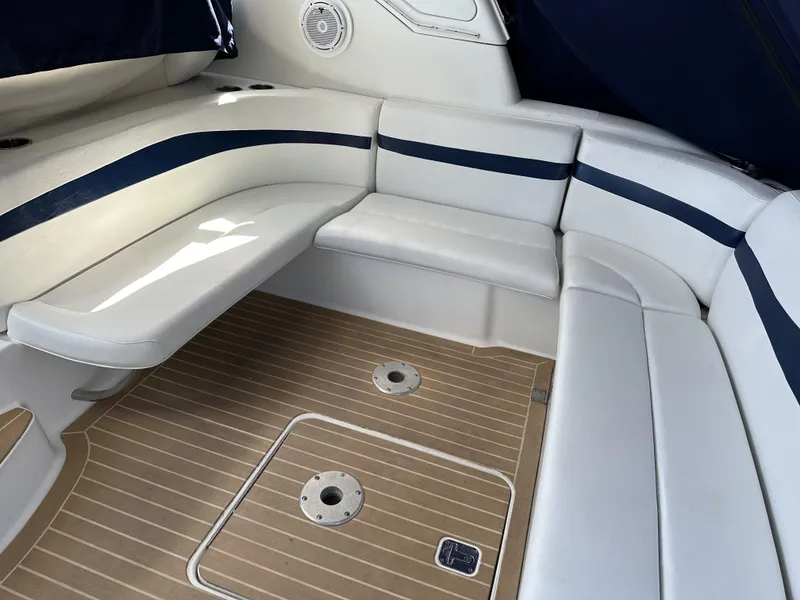 Slide: The Image of 2006 Formula 40 PC boat interior with white and blue seating, teak flooring. - 13