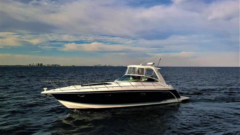 Slide: The Image of 2006 Formula 40 PC yacht cruising on open water under a partly cloudy sky. - 2