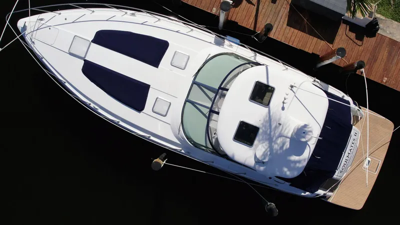Slide: The Image of Aerial view of a 2006 Formula 40 PC yacht docked at a wooden pier. - 3