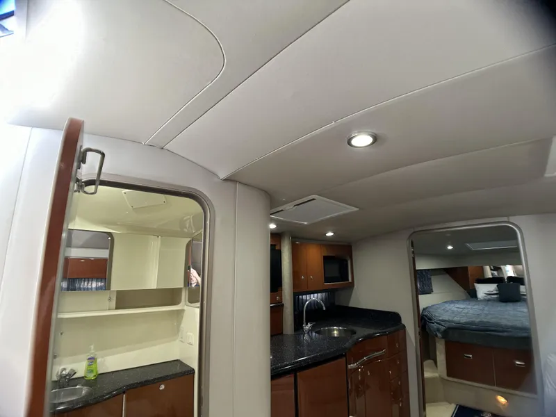 Slide: The Image of Interior of 2006 Formula 40 PC yacht with modern kitchen and cozy bedroom. - 40