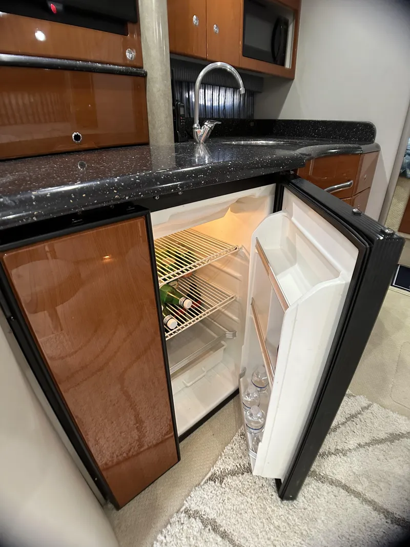 Slide: The Image of Open mini fridge in 2006 Formula 40 PC yacht kitchen with drinks inside. - 49