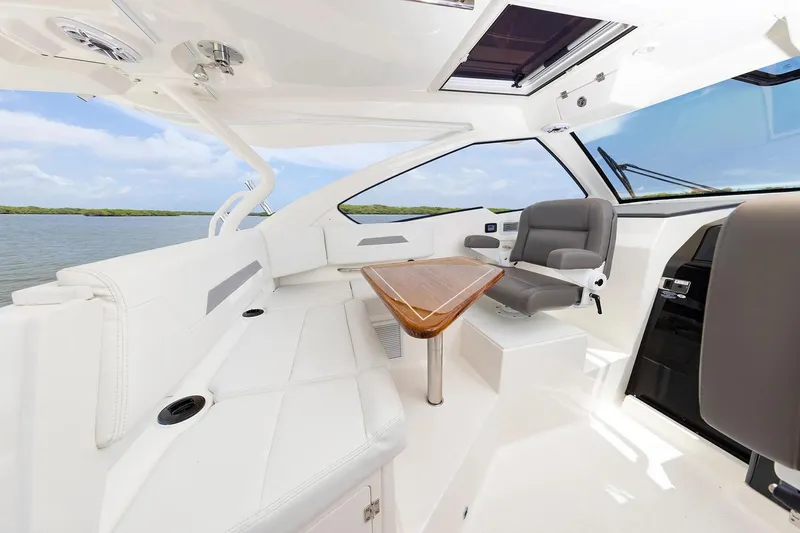 Slide: The Image of Manufacturer Provided Image: Luxurious interior of 2025 Pursuit OS 405 Offshore boat with sleek seating and table. - 10