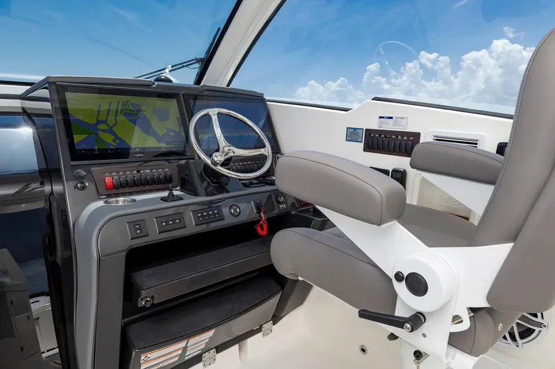 Slide: The Image of Manufacturer Provided Image: 2025 Pursuit OS 405 Offshore helm with modern controls and navigation displays. - 12