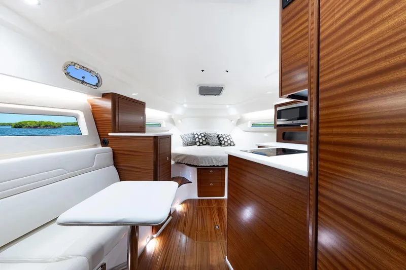 Slide: The Image of Manufacturer Provided Image: Luxurious interior of 2025 Pursuit OS 405 Offshore yacht with modern wood finishes. - 19