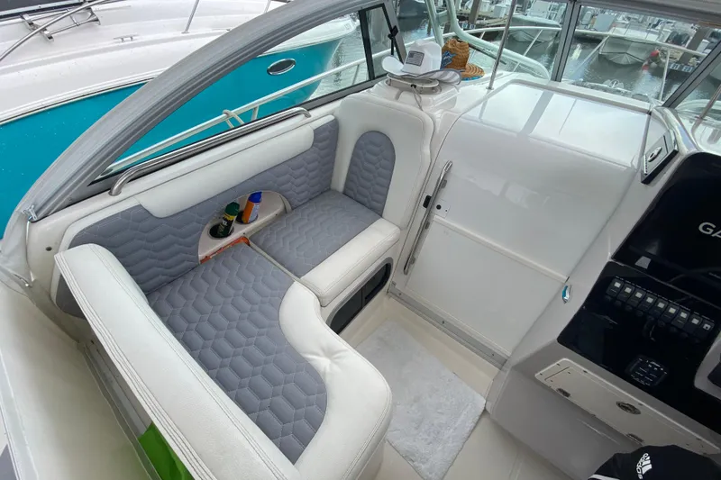 Slide: The Image of 2007 Robalo R305 Walkaround boat docked at marina with twin outboard engines. - 20