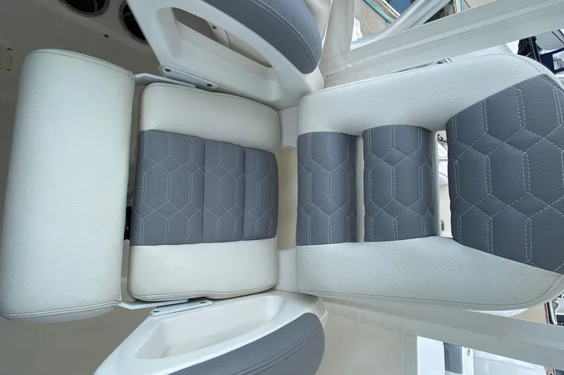 Slide: The Image of 2007 Robalo R305 Walkaround boat interior with seating and helm, docked at marina. - 22