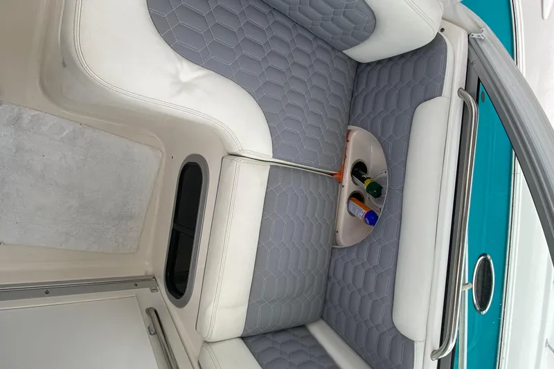 Slide: The Image of 2007 Robalo R305 Walkaround boat interior with cushioned seating and control panel. - 23