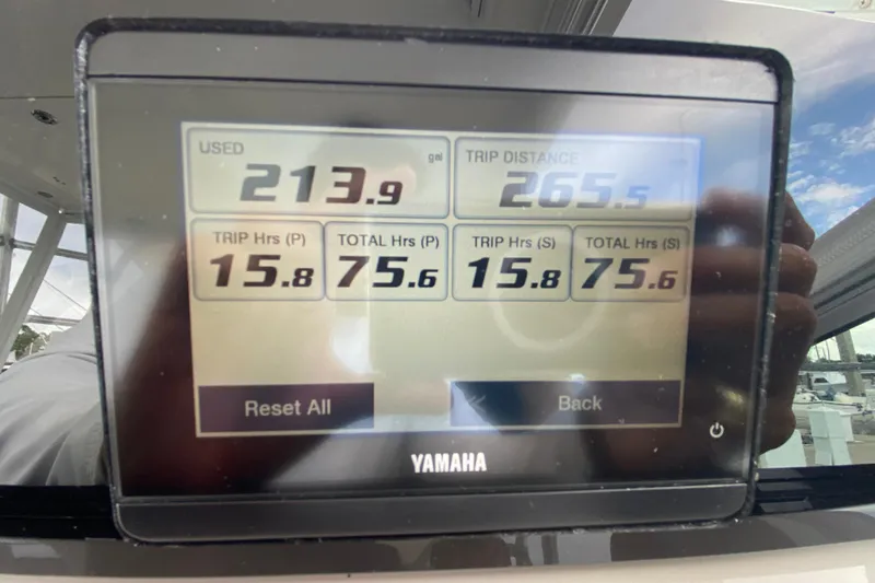 Slide: The Image of 2007 Robalo R305 Walkaround boat interior with steering wheel, seating, and navigation display. - 24