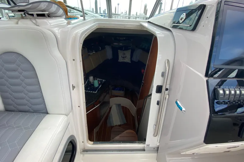 Slide: The Image of 2007 Robalo R305 Walkaround boat interior with gray seating and built-in cup holders. - 26
